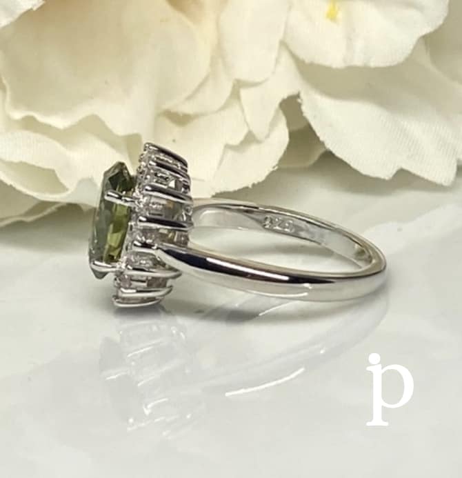 (AE-65) .925 Silver ring with peridot-colored zircons.